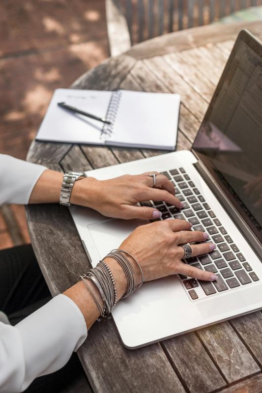 Woman typing on a computer.